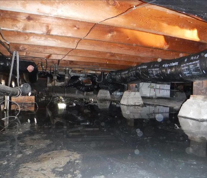 Photo shows standing water in a crawl space