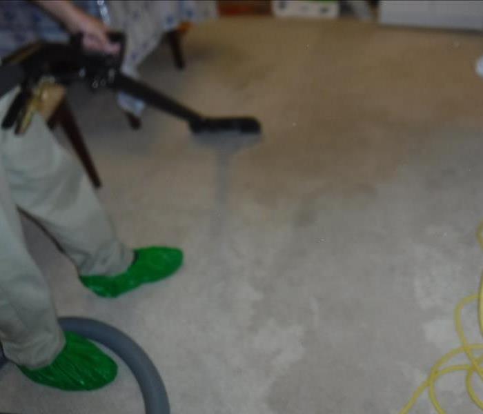 Photo shows our technicians extracting water from wet carpets